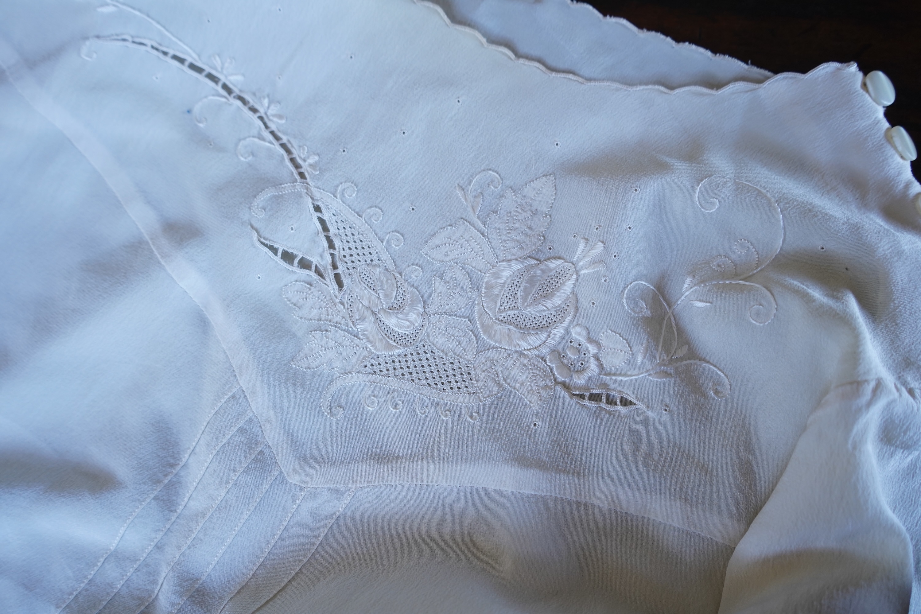 A collection of 1920's-30's silk and satin camisole slips, two cream silk and lace jackets, a lace blouse a silk embroidered blouse, a silk cami, and a collection of silk stockings., Condition- good